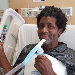 Man smiling in hospital bed