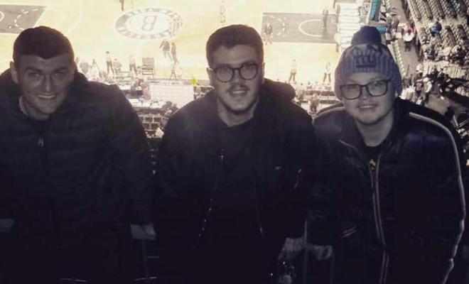 Barry smiling with his brothers at a sports game