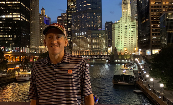 Nick smiling in front of the Chicago skyline.