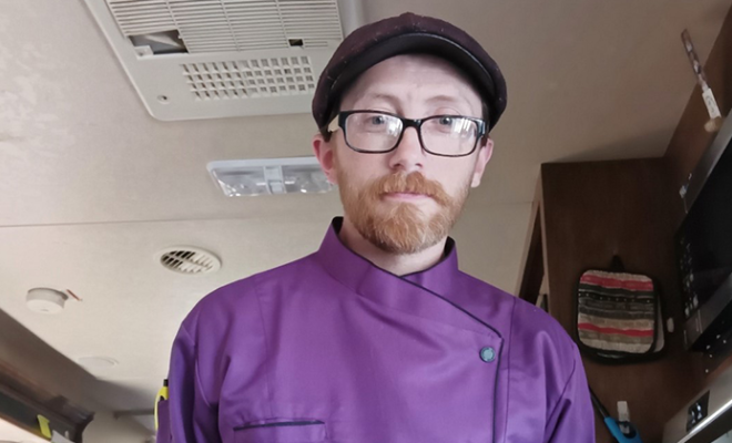 Patrick wearing a purple chef uniform.