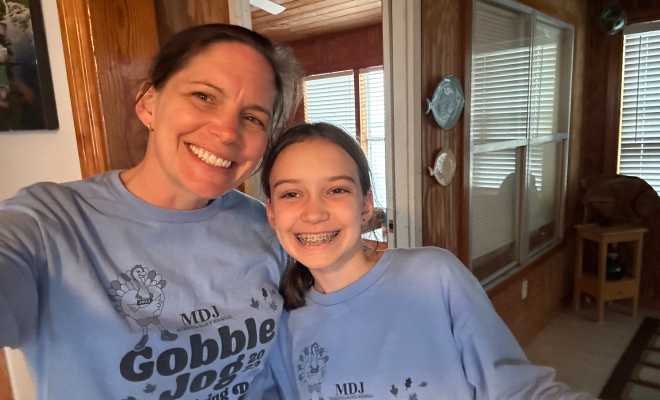 Stephanie and her daughter wearing matching "Gobble Jog" t-shirts