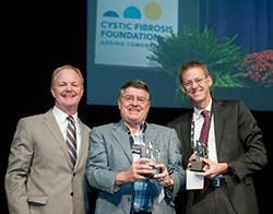 Christopher M. Penland presents the Richard C. Talamo Distinguished Clinical Achievement Award to Peter T. P. Bye and Scott H. Donaldson, two of the four recipients of the 2014 award.