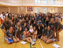 The sisters of the University of Miami pose for a picture with Delaney, 2, who has CF, at their Hoops for Hope basketball tournament.