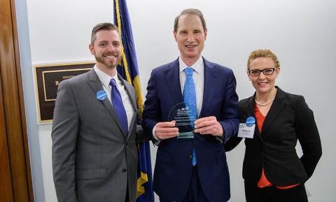 Senator Wyden accepts award from advocate during March on the Hill. 