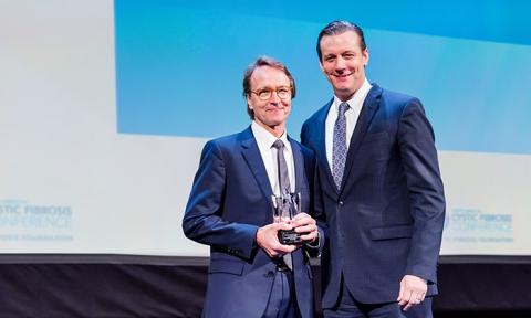 Michael P. Boyle, M.D. (right) presented Dr. George Z. Retsch-Bogart with the 2018 Richard C. Talamo Distinguished Clinical Achievement Award.